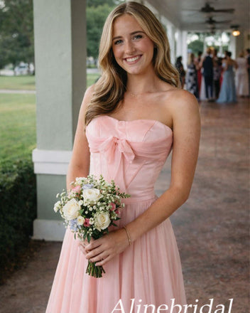 Woman in a pink strapless dress holding flowers, with 'Alinebridal' branding.