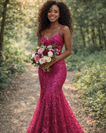 Woman in a pink sequin dress holding flowers in a forest setting, with 'AlineBridal' branding.